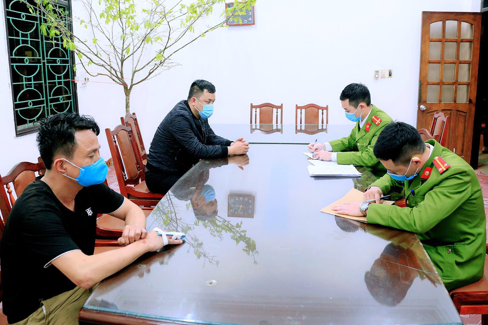 Đối tượng Phạm Văn Thuận (thứ nhất, bên trái) và Trần Văn Hùng (thứ hai, bên trái sang) tại Cơ quan điều tra.