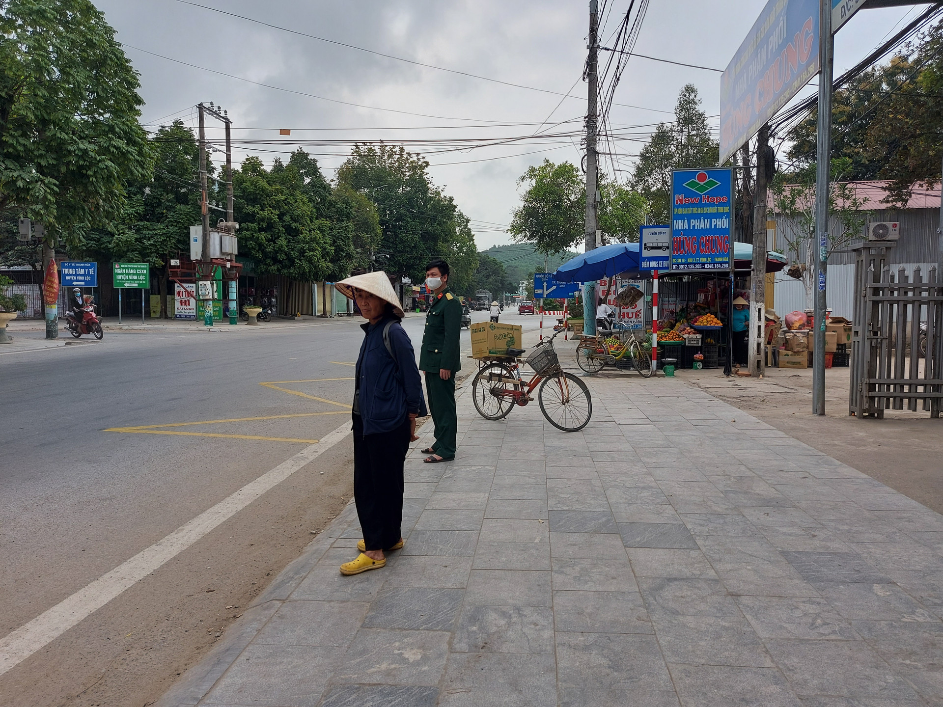  Người dân thị trấn Vĩnh Lộc (Thanh Hóa) hiện đã dễ dàng đứng chờ xe buýt tại điểm dừng đỗ được cắm biển, có vạch kẻ đường.
