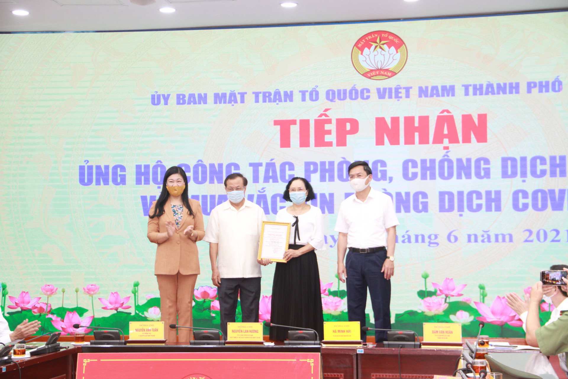 Bà Nguyễn Lan Hương, Chủ tịch Ủy ban MTTQ thành phố Hà Nội tiếp nhận ủng hộ từ các đơn vị. 