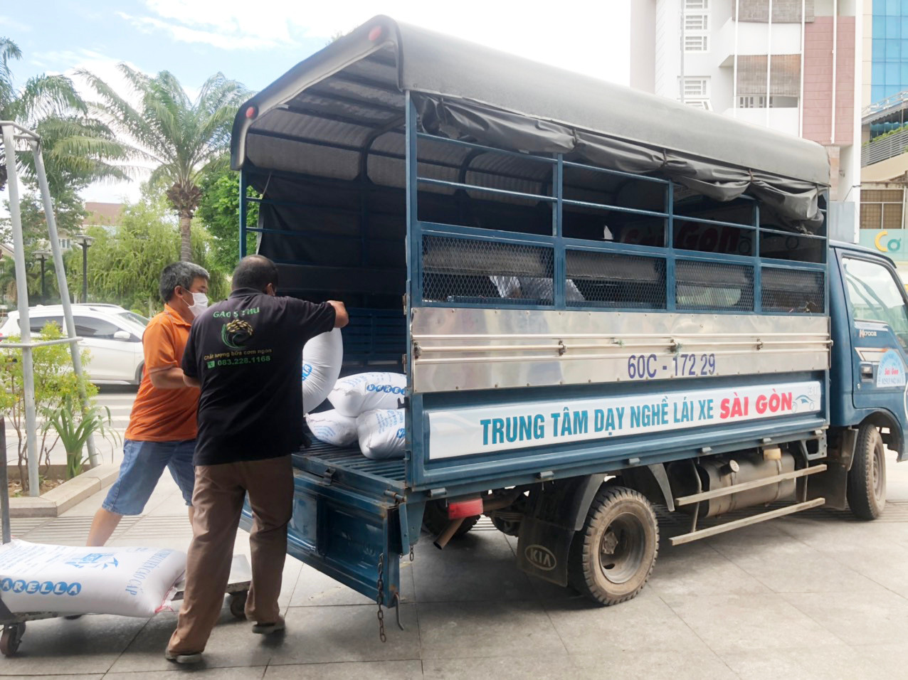 Chiếc xe tải tập lái của Trung tâm dạy nghề lái xe Sài Gòn chở những bao gạo, thùng mì mang tấm lòng thơm thảo đến với công nhân xóm trọ