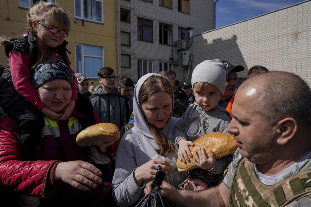 Người dân nhận thực phẩm viện trợ trong một sân trường ở Chernihiv, Ukraine. Ảnh: AP.