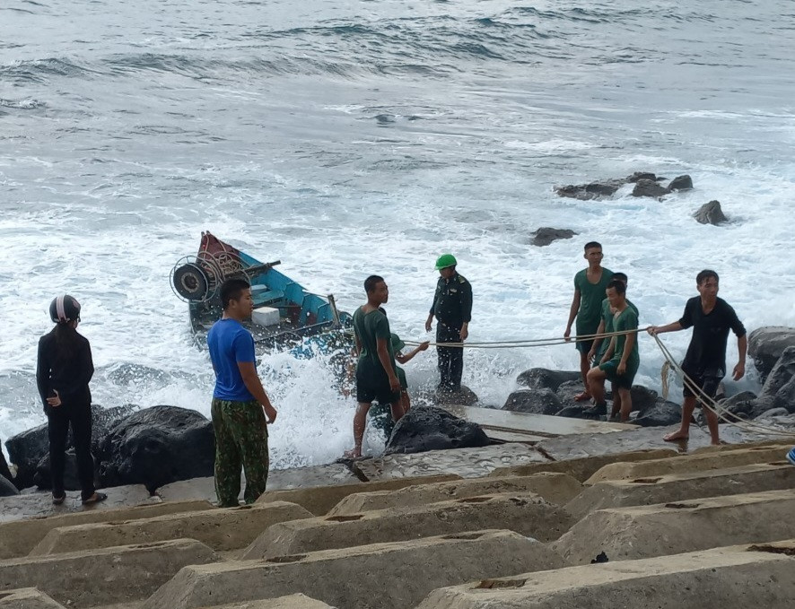 Đồn Biên phòng đảo Cồn Cỏ phối hợp với người dân kéo tàu gặp nạn lên bờ.