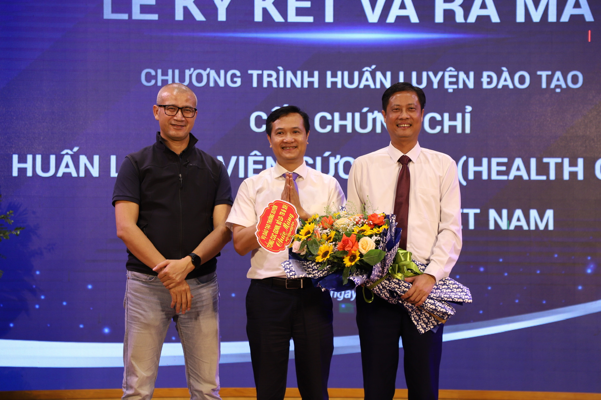 2.Ông Đào Trọng Độ, Vụ trưởng Vụ Đào tạo thường xuyên tặng hoa chúc mừng tại lễ ký kết hợp tác giữa nhà trường và Health Coach Việt Nam