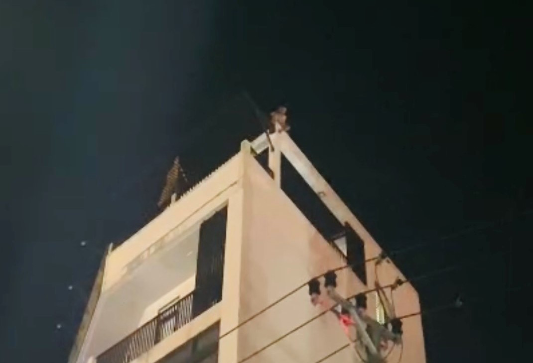 Nam thanh niên ở trên mái của ngôi nhà 4 tầng và có biểu hiện mất bình tĩnh. Ảnh: Phòng Cảnh sát PCCC và CNCH Công an tỉnh Quảng Trị.