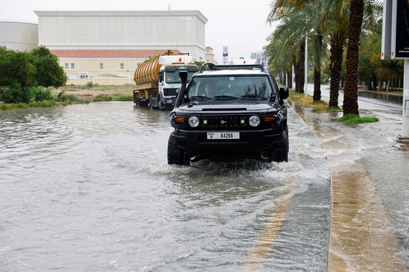 A driver navigates a flooded road following a rainstorm in Dubai on May 2, 2024. REUTERS/Rula Rouhana