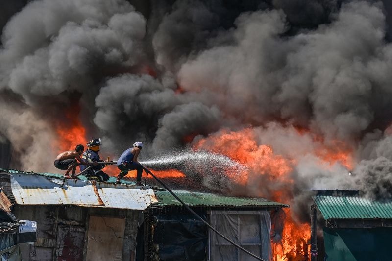 Residents and firefighters put out a fire at Tondo in Manila.